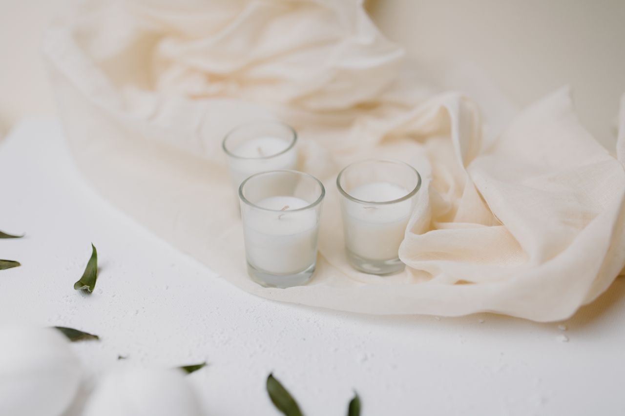 Stylish arrangement of candles and soft fabric, creating a serene spa ambiance for relaxation and self-care.